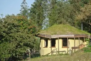 Here she is from the east in her new coat of paint ty mam mawr straw bale roundhouse