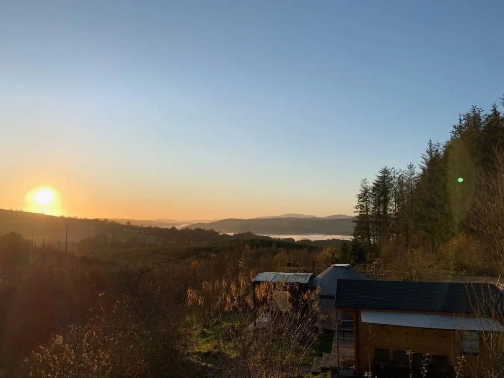 A clear winters sunset over ty crwn bach idris off grid sustainable eco glampsite and glamping