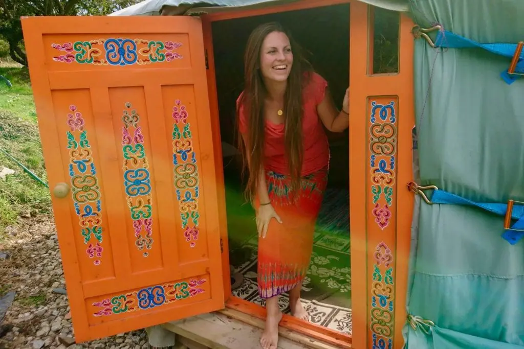 Guest coming out of ty crwn mawr off grid sustainable eco glampsite and glamping