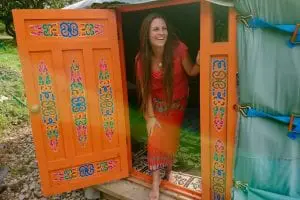 Guest coming out of ty crwn mawr off grid sustainable eco glampsite and glamping