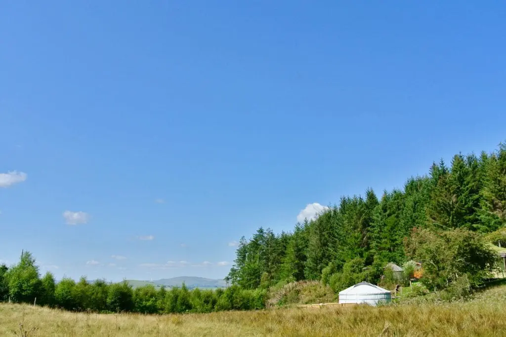 Ty crwn mawr yurt a view from the field off grid sustainable eco glampsite and glamping
