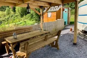 Ty crwn mawr yurt outside covered dining area and fire pit 10 off grid sustainable eco glampsite and glamping