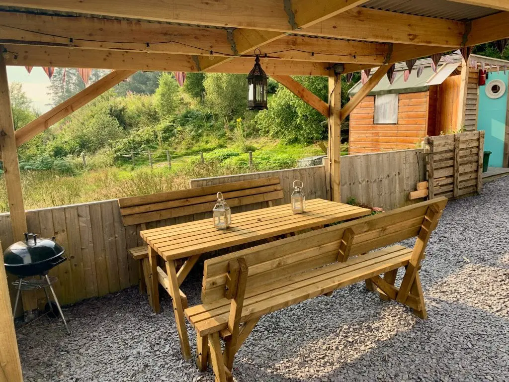 Ty crwn mawr yurt outside covered dining area and fire pit 11 off grid sustainable eco glampsite and glamping