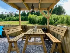 Ty crwn mawr yurt outside covered dining area and fire pit 2 off grid sustainable eco glampsite and glamping