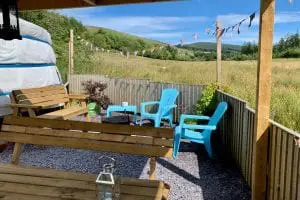Ty crwn mawr yurt outside covered dining area and fire pit 7 off grid sustainable eco glampsite and glamping