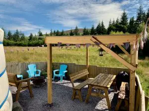 Ty crwn mawr yurt outside covered dining area and fire pit off grid sustainable eco glampsite and glamping