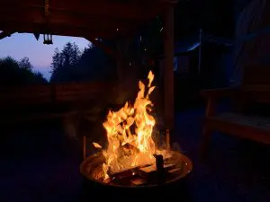 Ty crwn mawr yurt outside covered dining area and firepit nighttime and evening 6 off grid sustainable eco glampsite and glamping
