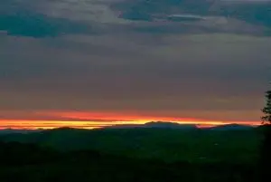 Sunset over arenig vawr off grid sustainable eco glampsite and glamping