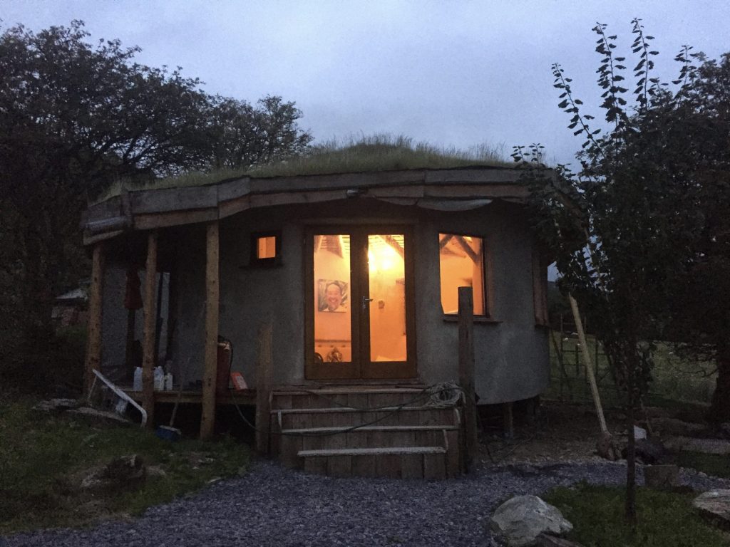 The straw bale roundhouse iIlluminated from the inside - nearly finished now and ready for painting