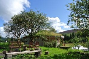 The straw bale roundhouse and central fire pit at ty mam mawr off grid eco retreat centre