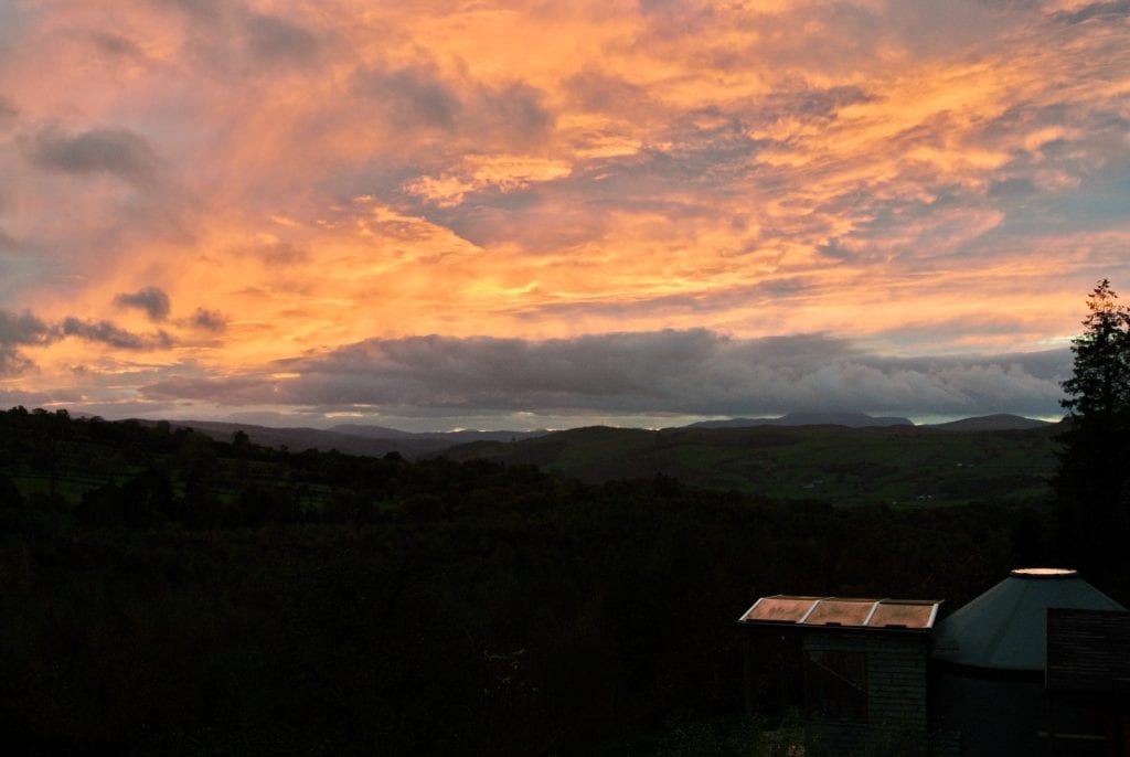 Spring sunset over ty crwn bach idris off grid sustainable eco glampsite and glamping