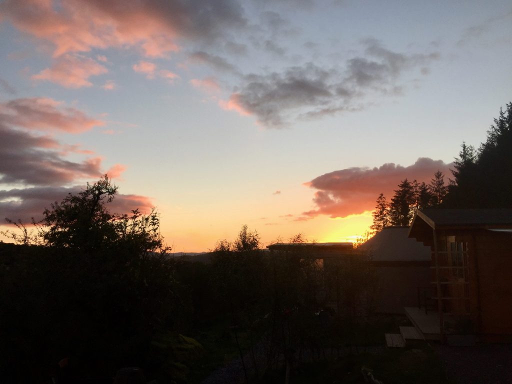 Sunset over ty crwn bach idris off grid sustainable eco glampsite and glamping