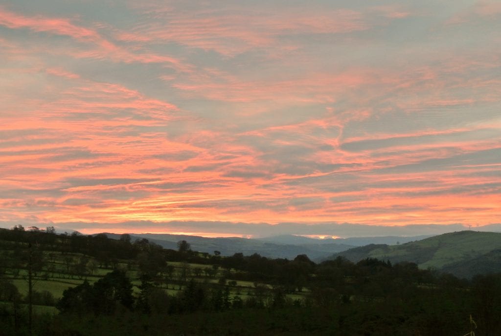 Ty crwn bach idris yurt red evening sky off grid sustainable eco glampsite and glamping