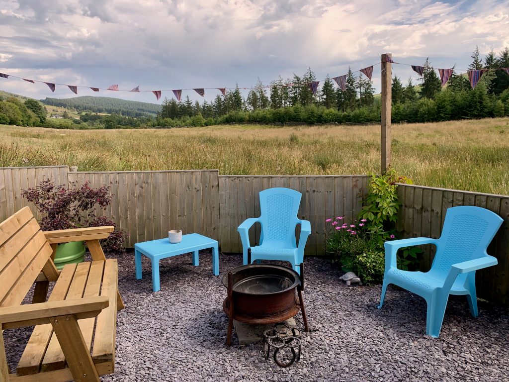 Ty crwn mawr yurt outside covered dining area and fire pit 6 off grid sustainable eco glampsite and glamping