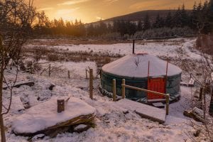 Ty crwn mawr yurt spacious and cosy authentic mongolian yurt exterior in the snow off grid sustainable eco glampsite and glamping