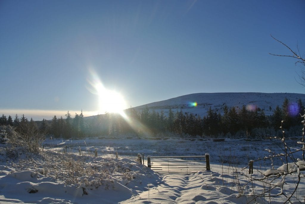 A snowy winter day sunrise over moel henfaes at greener glamping