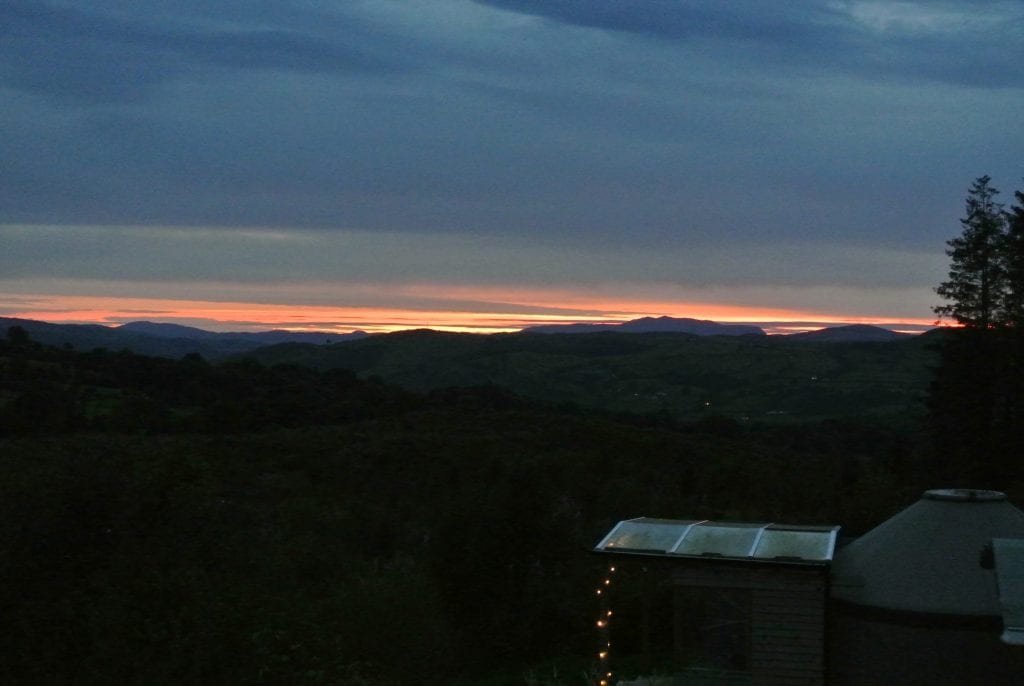 Sunset over ty crwn bach off grid sustainable eco glampsite and glamping
